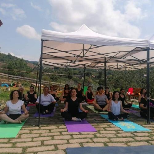 a group of people sitting on yoga mats under a tent at Chamich Guesthouse in Debed