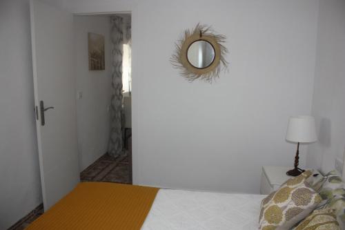 a bedroom with a bed with a mirror on the wall at La Moradita in Vejer de la Frontera