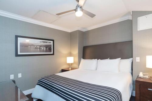 a hotel room with a bed and a ceiling fan at Sandman Hotel Vancouver Airport in Richmond