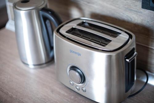 a toaster sitting on a counter next to a coffee pot at Sunset View Ski & Spa apartments Kopaonik in Kopaonik