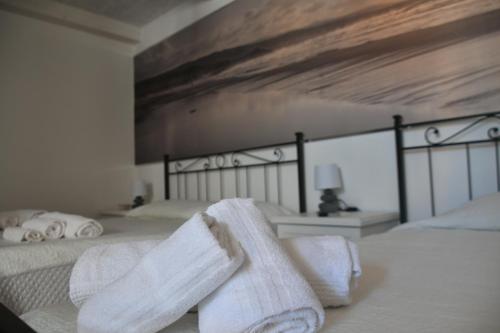 a bedroom with two white towels on a bed at Angelique Affittacamere in Santa Teresa Gallura