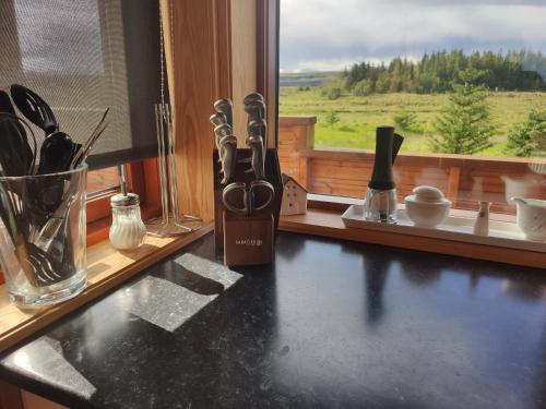 a counter top with scissors on a window sill at Bright and Peaceful Cabin with Views & Hot Tub in Selfoss