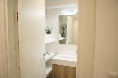 a bathroom with a sink and a mirror at Casa Sant'Orsola - Appartamento nella città antica in Molfetta