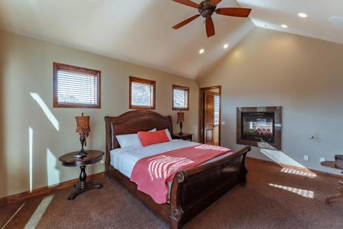 a bedroom with a bed and a ceiling fan at Zion Ponderosa Ranch Resort in Springdale