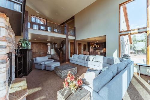 a large living room with blue furniture and a large window at Zion Ponderosa Ranch Resort in Springdale