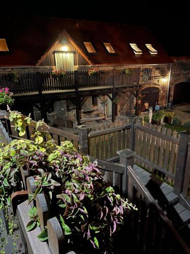 a group of benches with potted plants in front of a building at Agroturystyka Hanka i Jurek in Boruja