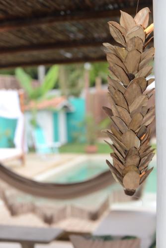 a close up of a feather in front of a pool at Casa Alegre Trancoso, piscina, 3 suítes e ar-cond. in Trancoso