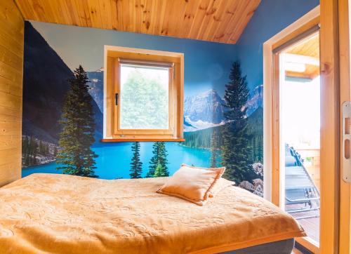 a bedroom with a large window and a bed at LandsBy Apartments in Ostrów Warcki