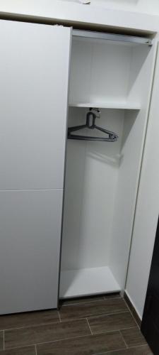 a closet with a white cabinet and a desk at Apartman Cer in Banja Koviljača
