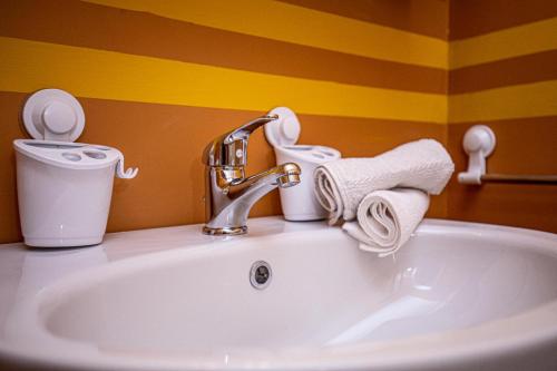 a bathroom sink with a faucet and towels on it at Giannella Tuscany Holidays in Giannella