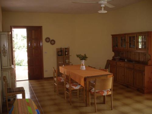 a dining room with a wooden table and chairs at Villa Dolci Vacanze in Fontane Bianche