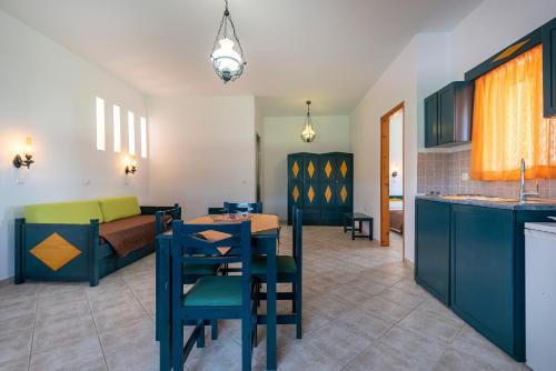 a kitchen and living room with a table and chairs at Cirillo Family Hotel-Christinas Studios in Mastichari