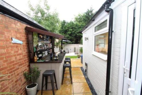 a bar on the side of a building at The Villas - Modern Comfort, 15 mins to Silverstone and Milton Keynes - Free parking, Prime, Netflix in Buckingham