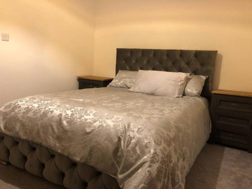 a bedroom with a large bed and two night stands at The Villas, Newly refurbished modern home - Free parking, Prime, Netflix in Buckingham