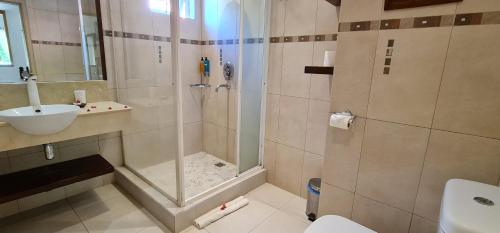 a bathroom with a shower and a sink at Ocean Villas Apart Hotel by Ocean Hospitality in Grand Baie