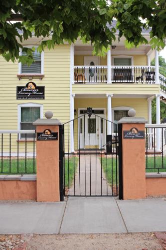 a yellow house with a gate in front of it at Bowen Motel in Moab