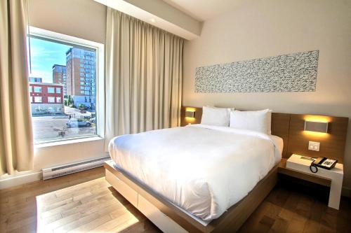 Postel nebo postele na pokoji v ubytování Hôtel Le Navigateur