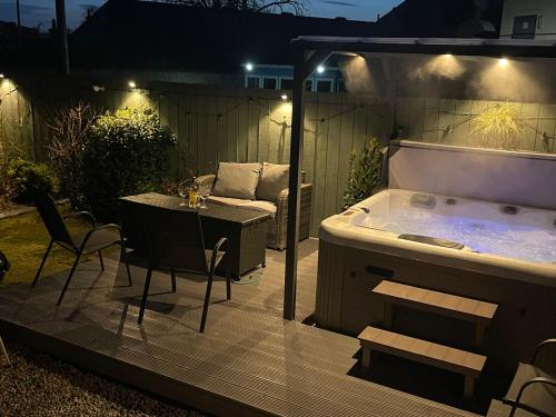 a jacuzzi tub in a backyard at night at Ardentorrie Holiday Home in Inverness