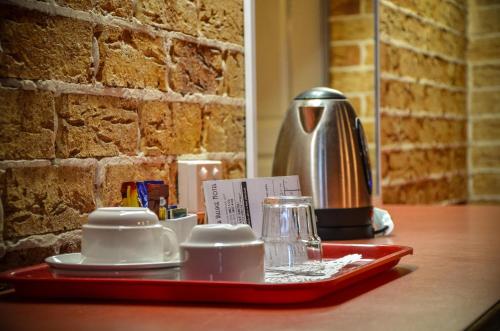 una bandeja con tazas y platillos en una mesa en Beenleigh Village Motel, en Beenleigh