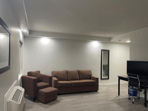 a living room with a couch and a flat screen tv at Radisson Hotel & Conference Centre Edmonton in Edmonton