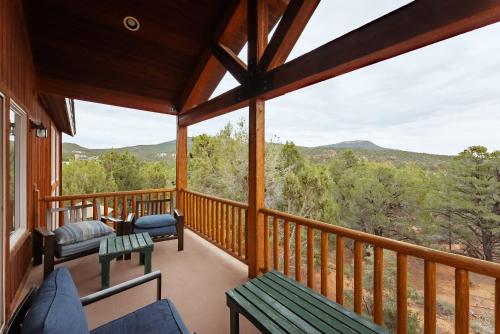 a screened in porch with a view of the mountains at Zion Ponderosa Ranch Resort in Springdale