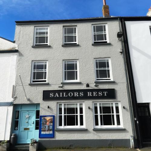 a building with a sign that reads sellers rest at Sailors Rest in Appledore