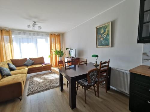 a living room with a couch and a table at Milusi Domek in Łagów