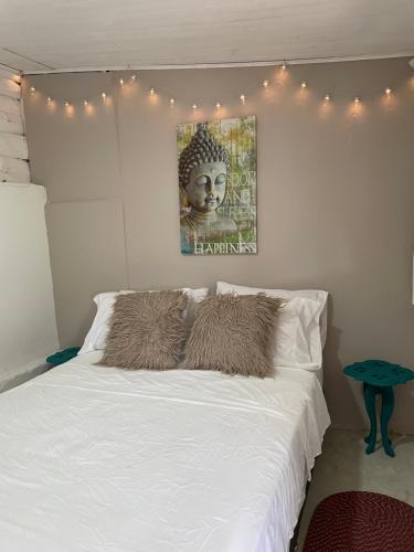 a bedroom with a white bed with lights on it at Cabañas Valle del Cocora La Truchera in Salento