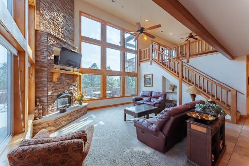 a living room with a couch and a fireplace at Zion Ponderosa Ranch Resort in Springdale