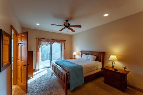 a bedroom with a bed and a ceiling fan at Zion Ponderosa Ranch Resort in Springdale