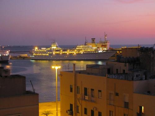 a cruise ship is docked in a harbor at night at A Babordo B&B in Trapani