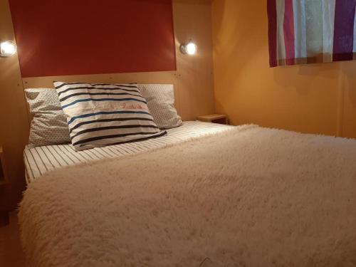 a bedroom with a bed with a pillow on it at Le Lolipop in Capbreton