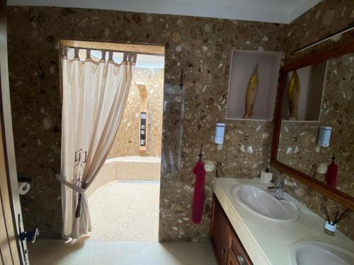 a bathroom with a shower and a sink and a mirror at La Duomo di Vulcano in Playa Honda