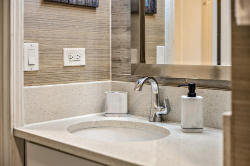 a bathroom counter with a sink and a mirror at Picturesque Hotel Room with Private Balcony in Waikiki! in Honolulu