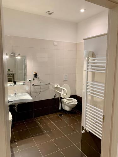 a bathroom with a toilet and a sink at Romano B&B in Bari