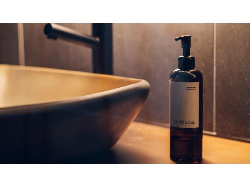 a bottle of soap sitting next to a sink at nol kyoto sanjo - Vacation STAY 97692v in Kyoto