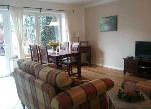 a living room with a couch and a table at Liebevoller Landhaustraum in Ratekau