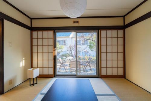 a room with a blue mats in front of a window at Garden Villa Yugawara Kajiya - Vacation STAY 23110v in Mongawa