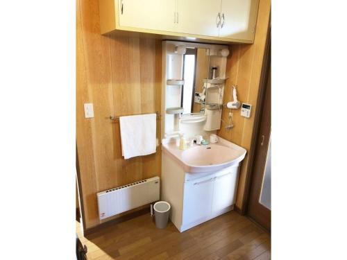 La petite salle de bains est pourvue d'un lavabo et d'un miroir. dans l'établissement Guest House Nusa - Vacation STAY 12651, à Kushiro