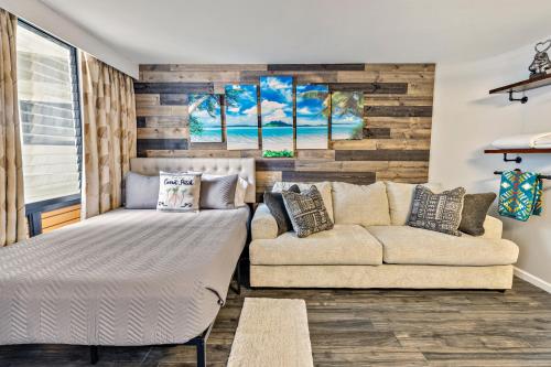a living room with a bed and a couch at Inviting Waikiki Grand Hotel Room One Block to Beach! in Honolulu