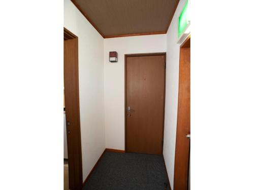 a hallway with a door and a carpet at Guest House Tou - Vacation STAY 26341v in Kushiro