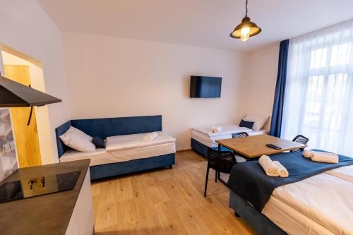 a room with two beds and a couch and a table at Benátky 214 in Vranov nad Dyjí