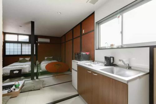a kitchen with a sink and a bed in a room at Oyado NAKAZ1 - Vacation STAY 27690v in Osaka
