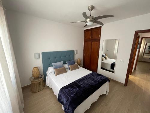 a bedroom with a bed and a ceiling fan at Luxury Suite San Borondón in Playa Honda