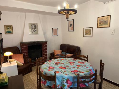a living room with a table and a fireplace at Casa Dora in Brusino Arsizio