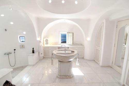 a white bathroom with a sink and a tub at Villa Zen in Mikonos
