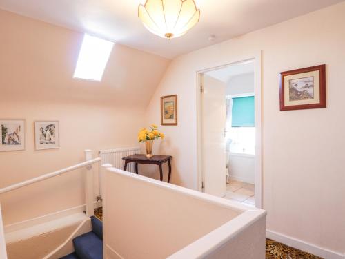 a staircase in a home with a light fixture at Holly Hoose in Findochty