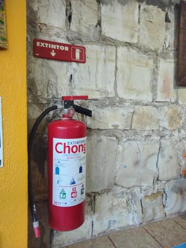 a fire hydrant is attached to a brick wall at Kali Huasteca Posada in Ciudad Valles