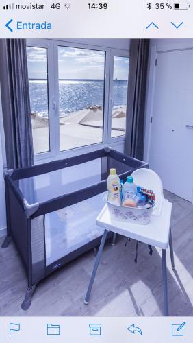 a table with toys on it in front of a window at Luxury Suite Sea Front III in Playa Honda