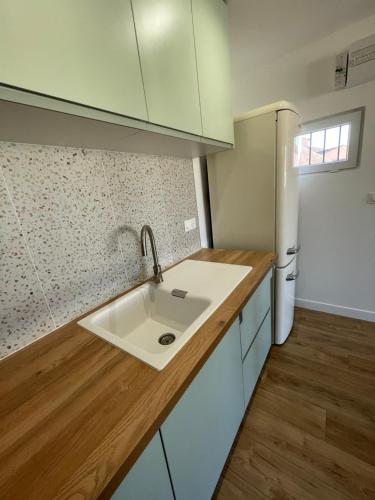a kitchen with a sink and a refrigerator at Superbe T2 avec vue mer et piscine in La Croix-Valmer